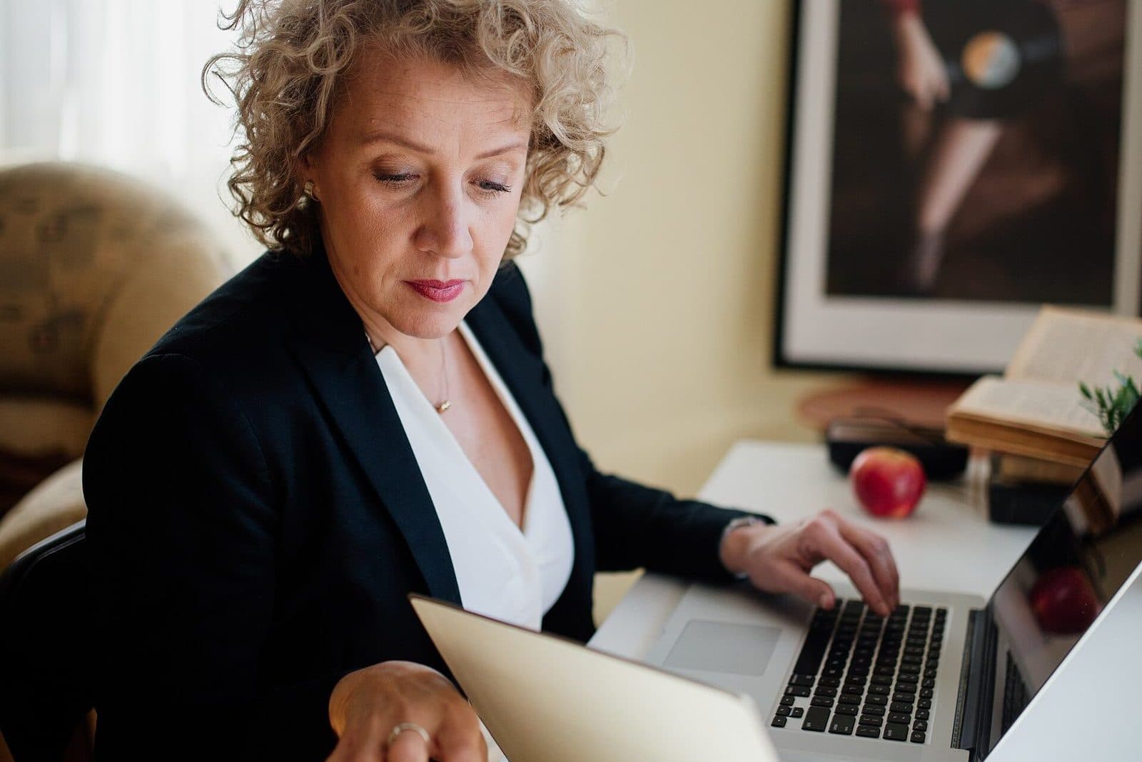 Finance administrator reviewing customer account documents at a desk