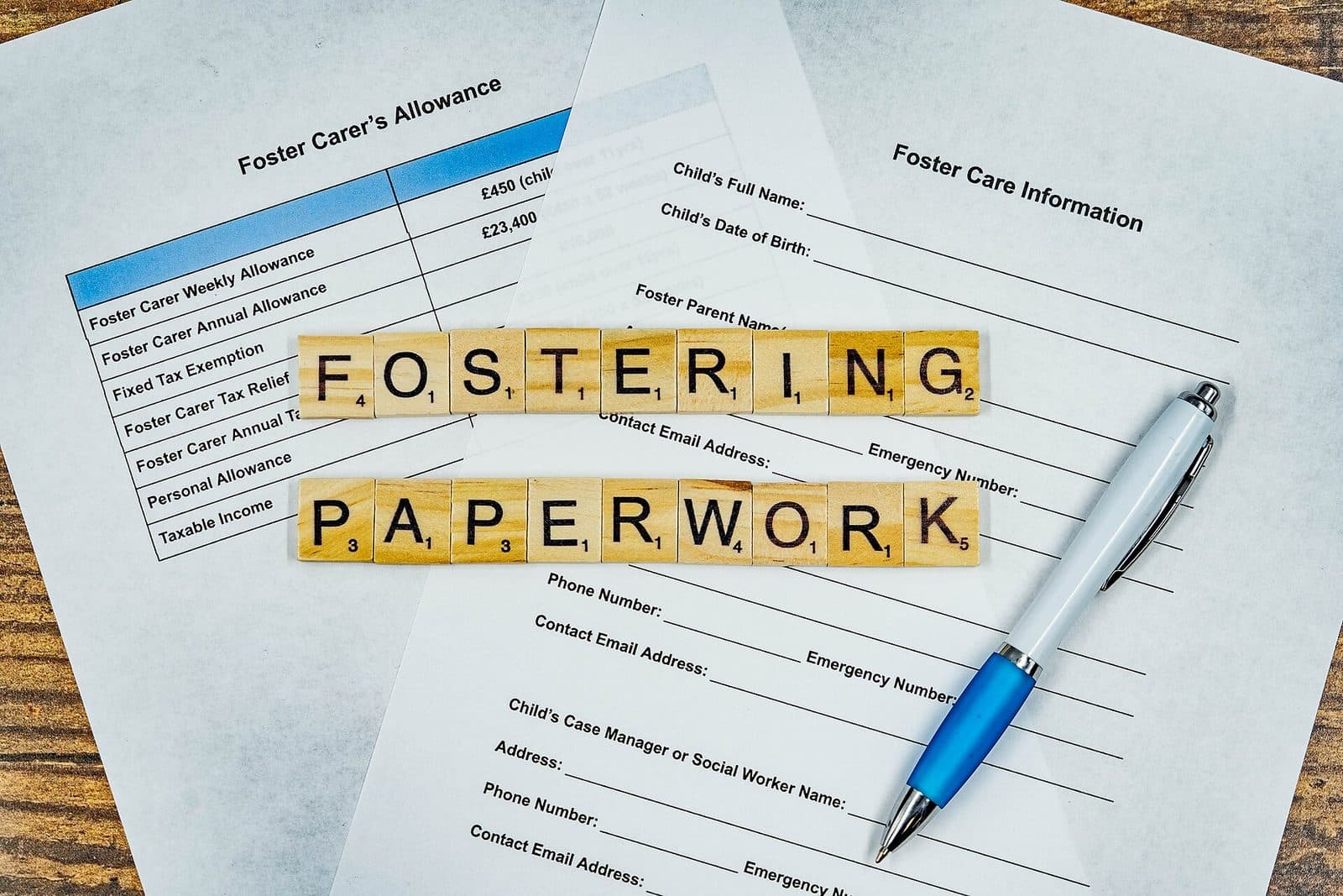 Employee forms and paperwork arranged for an onboarding review